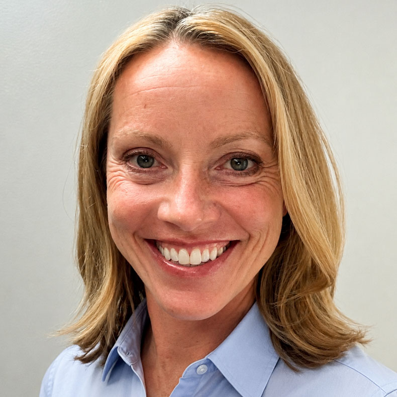 Portrait of smiling woman with blonde hair and light blue shirt