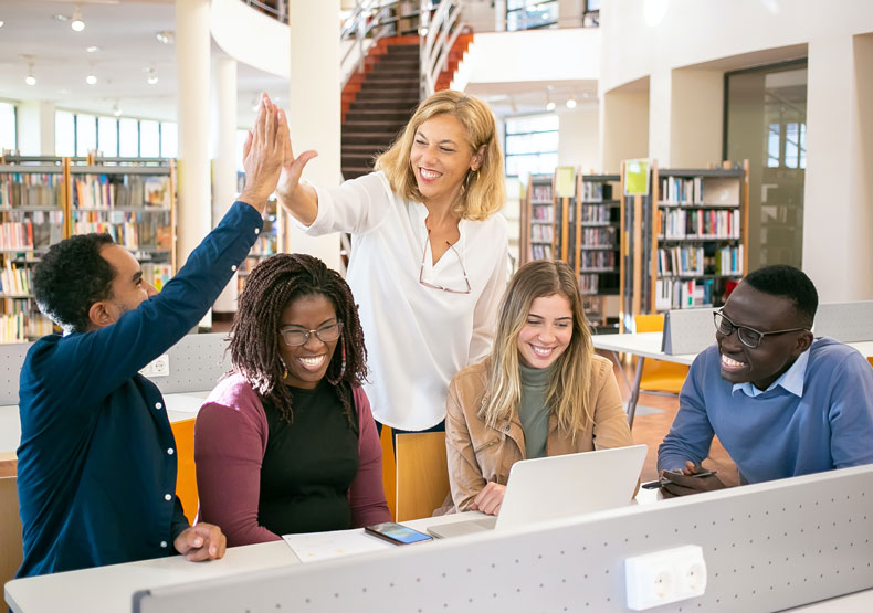 Group of adults in a library setting working together