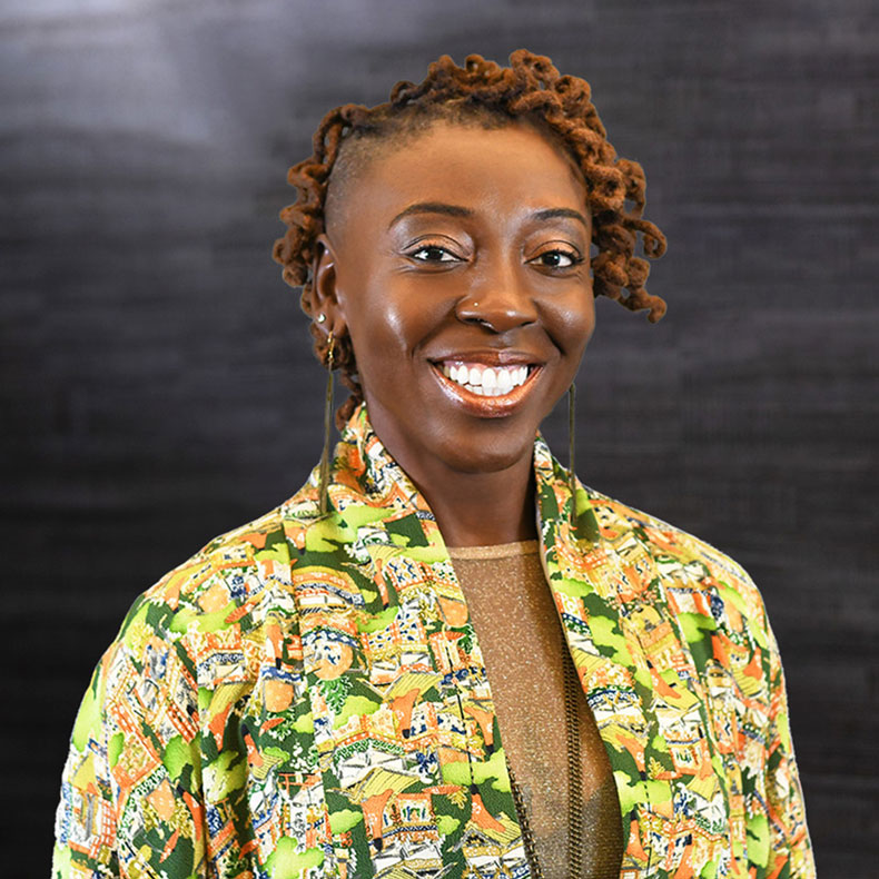 Portrait photo of black woman in shirt with green pattern