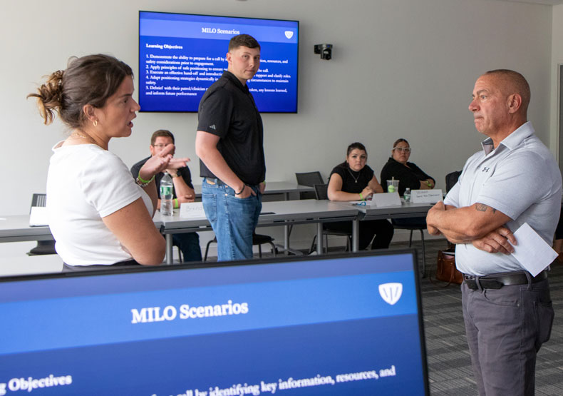 Group of people in a classroom discussing an issue