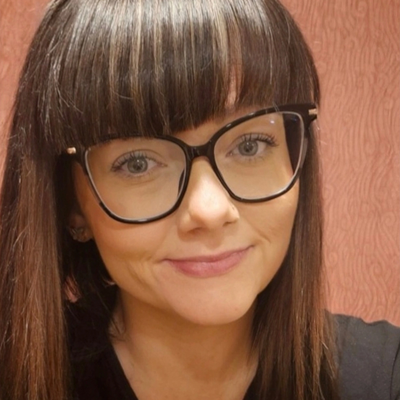Portrait photo of woman with glasses and bangs
