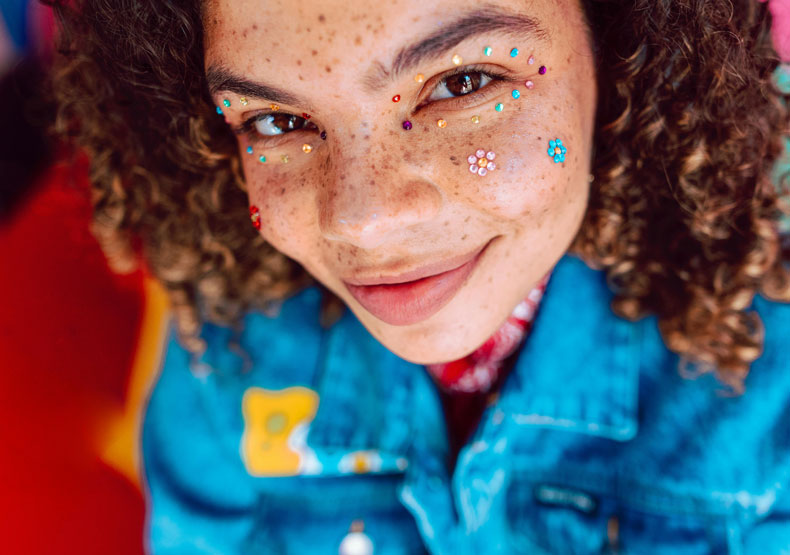 close up of adolescent with sparkle stickers on face