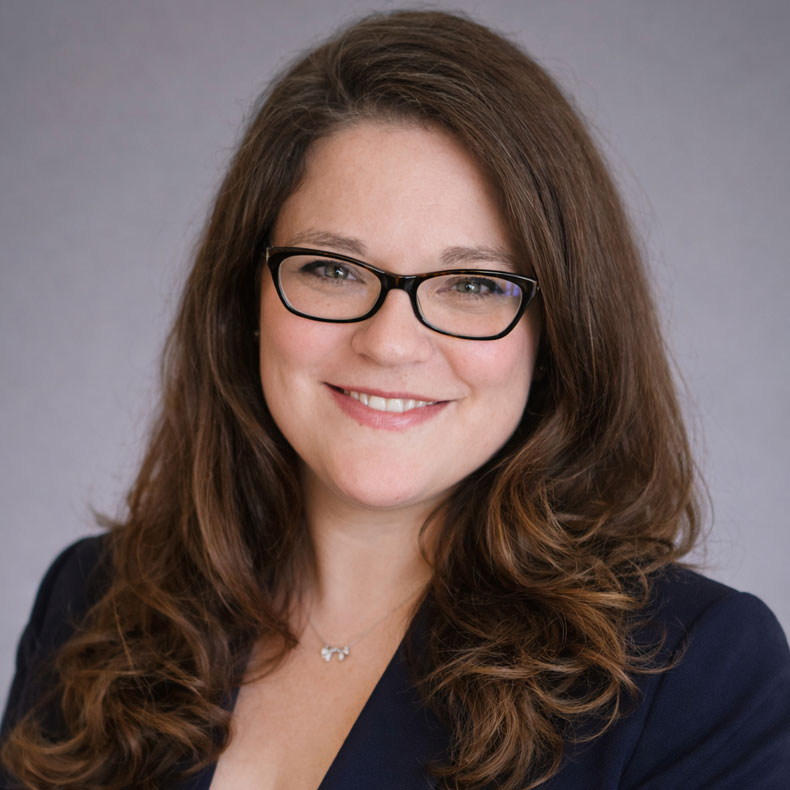 Jenny D'Olympia, PsyD, LMHC profile photo of woman with glasses smiling