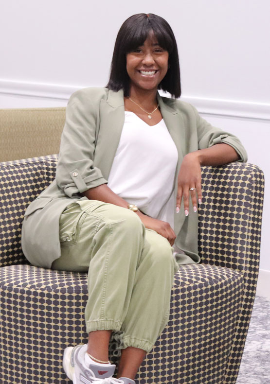 Black woman sitting in checker-patterned chair