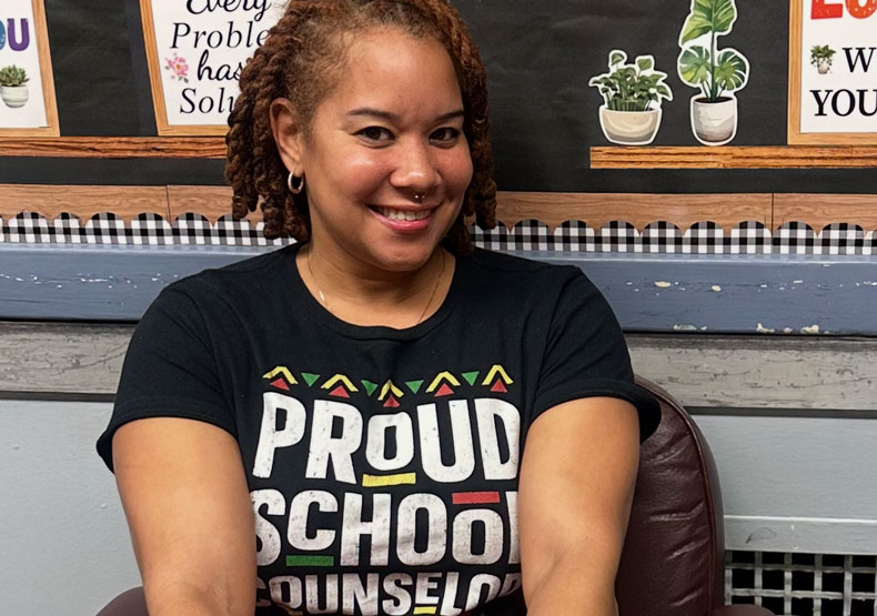 women in front of a bulletin board