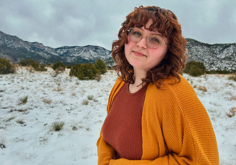 person in front of mountain range
