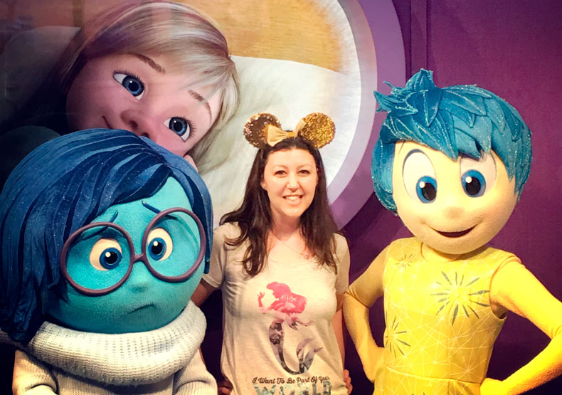 woman standing with disney characters