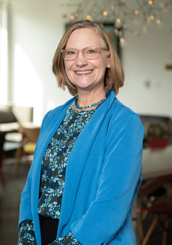 woman in blue jacket posing for camera