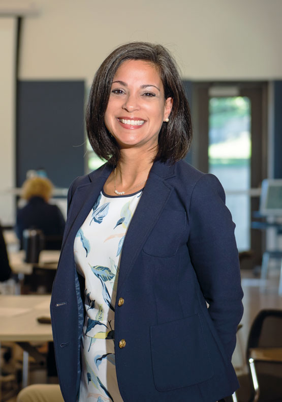 woman in dark blue jacket posing for camera