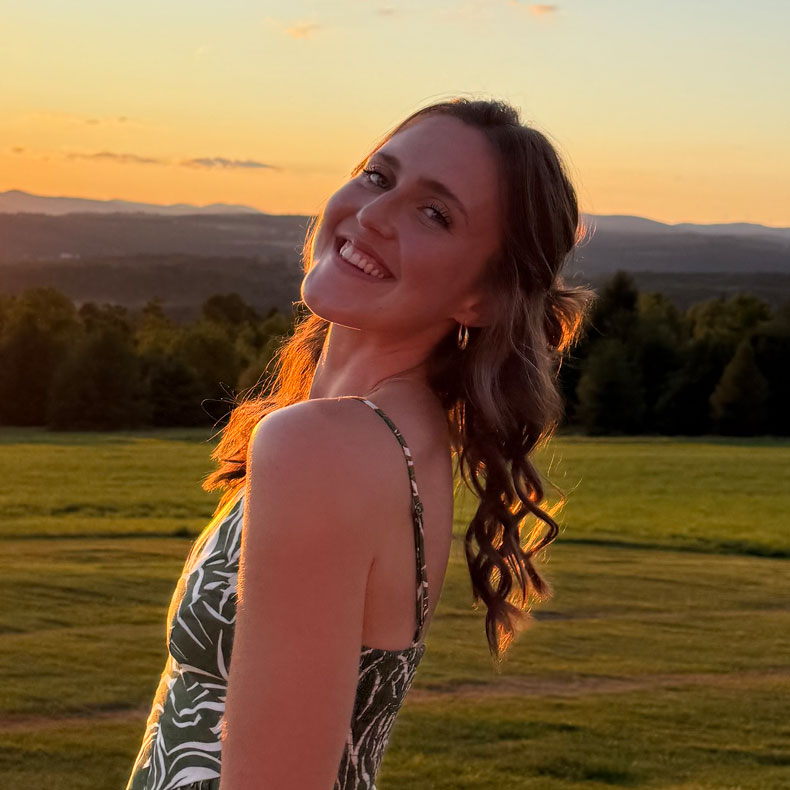 Photo of white woman with long hair, sundress, with sunset and outdoor scene